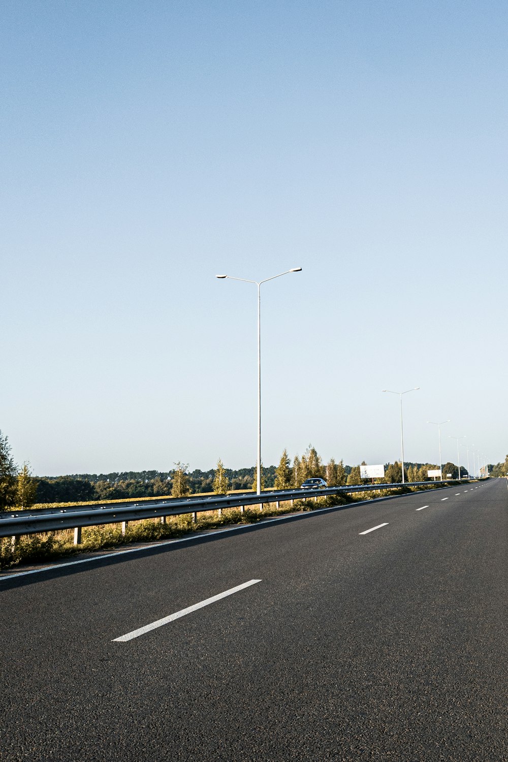 black asphalt road under blue sky during daytime