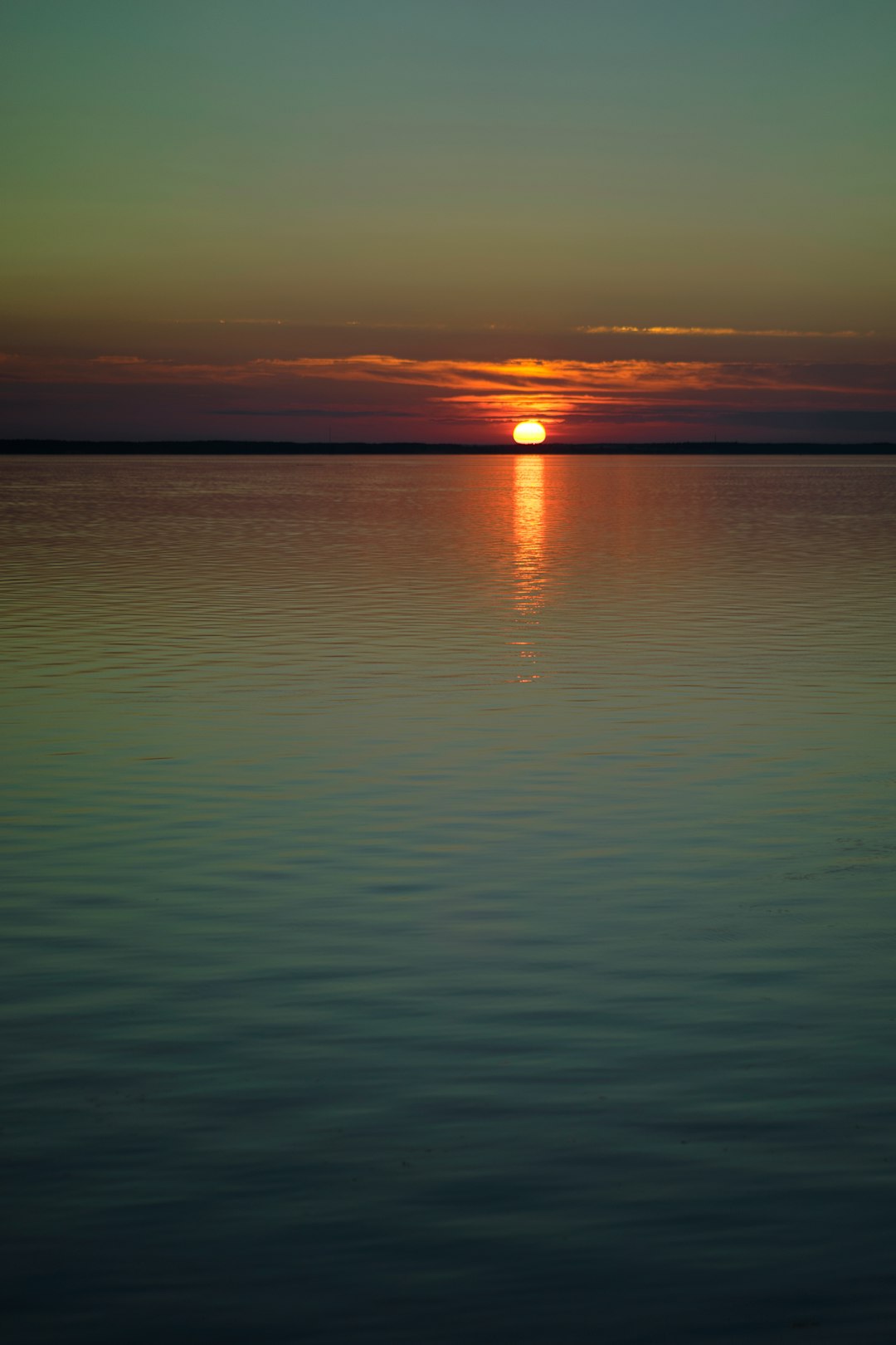 calm sea under orange sky during sunset