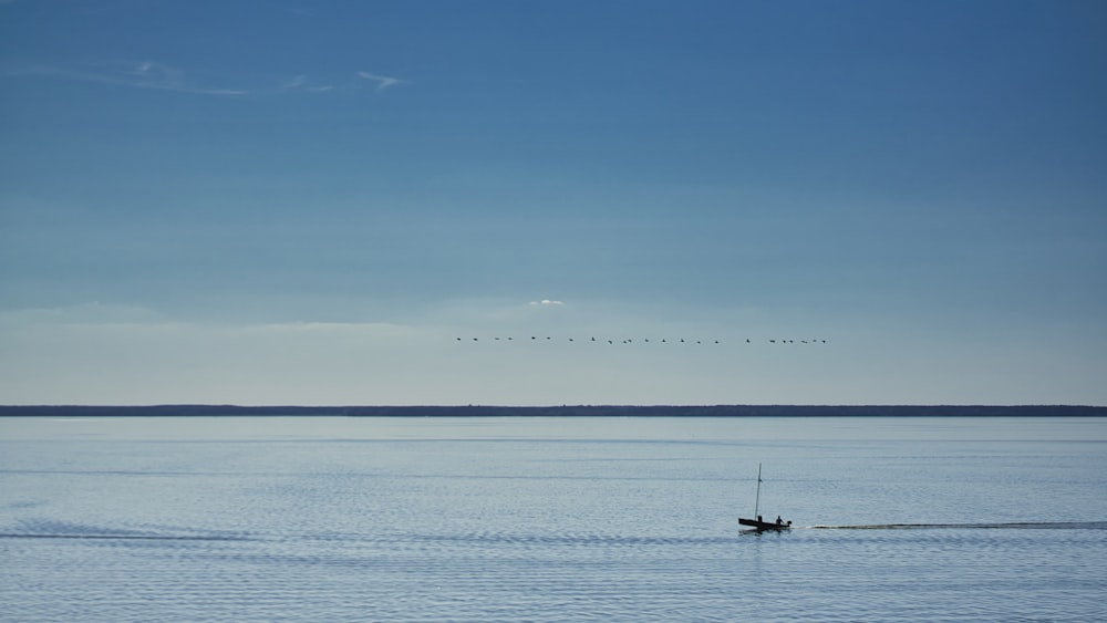 people riding boat on sea during daytime