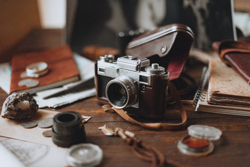 black and silver camera on brown wooden table