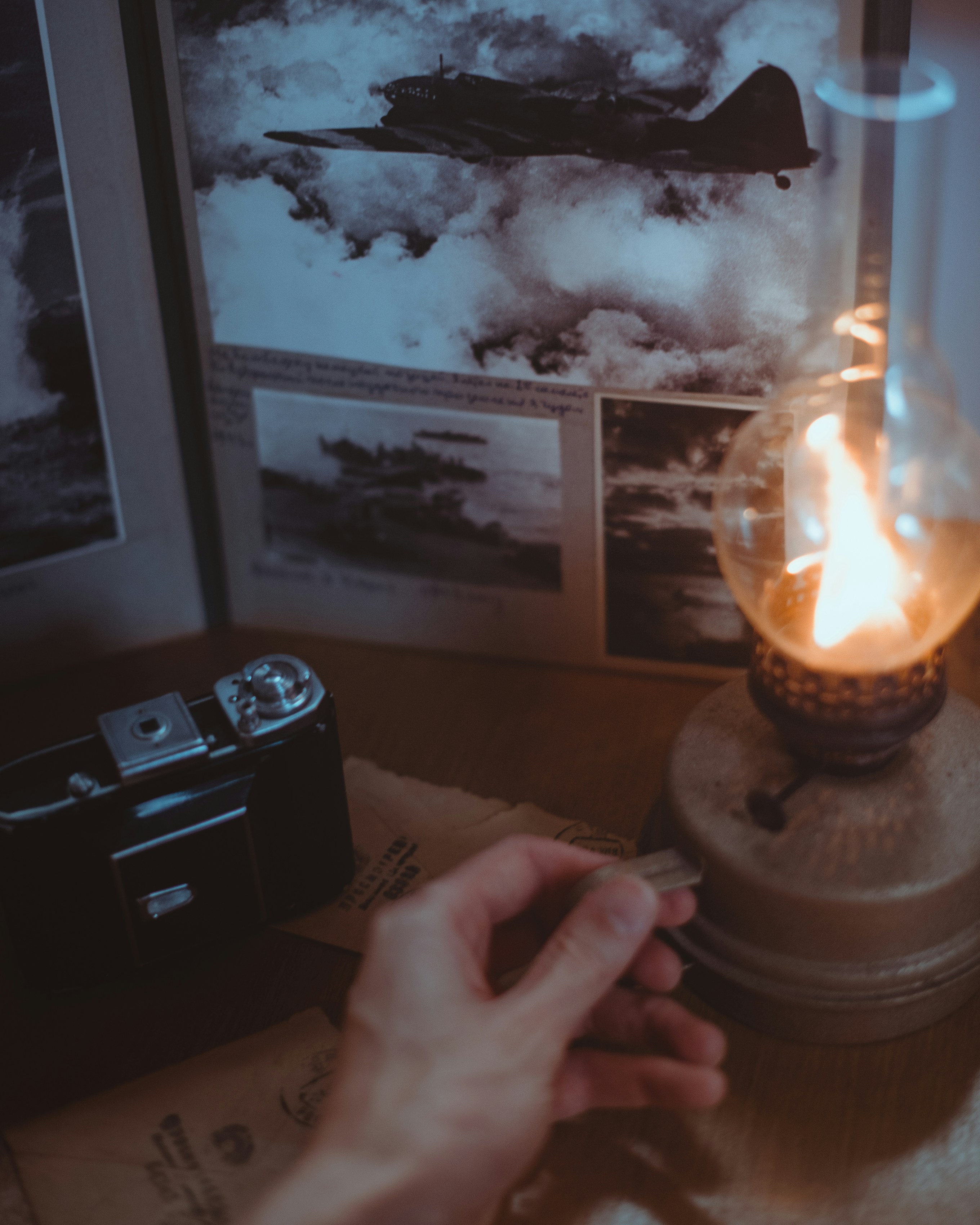person holding lighted candle in brown wooden table
