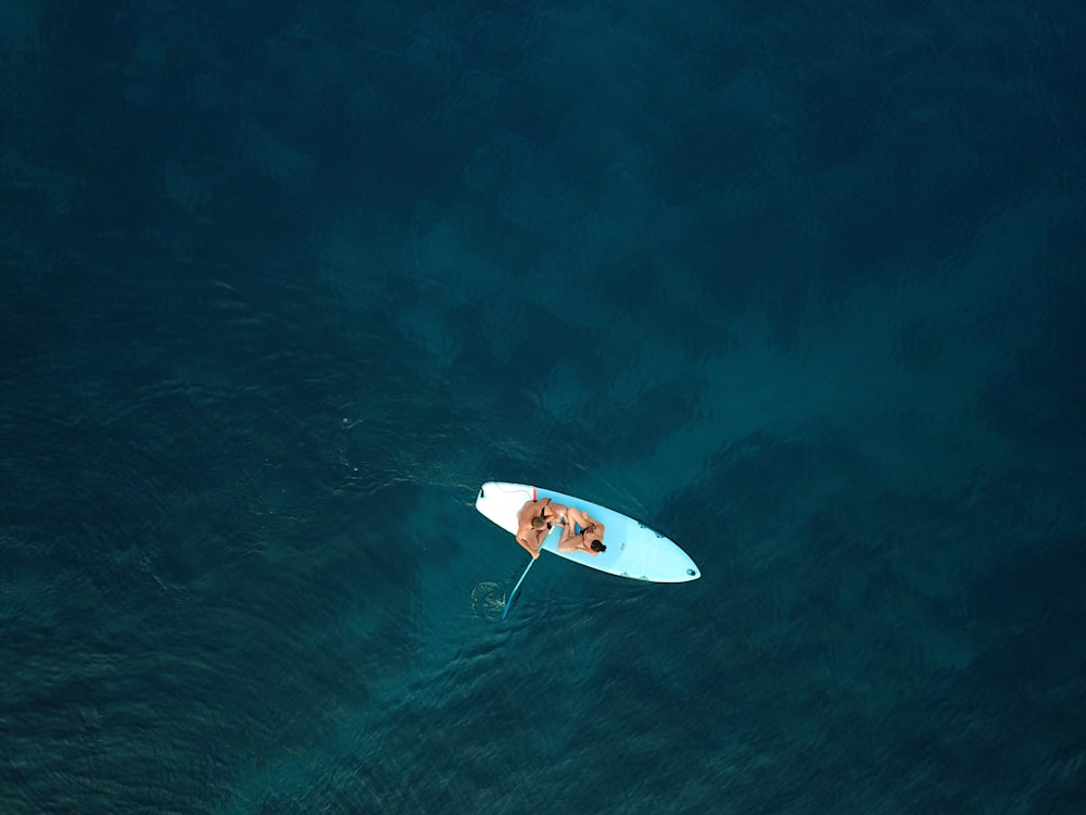 person surfing on blue sea during daytime