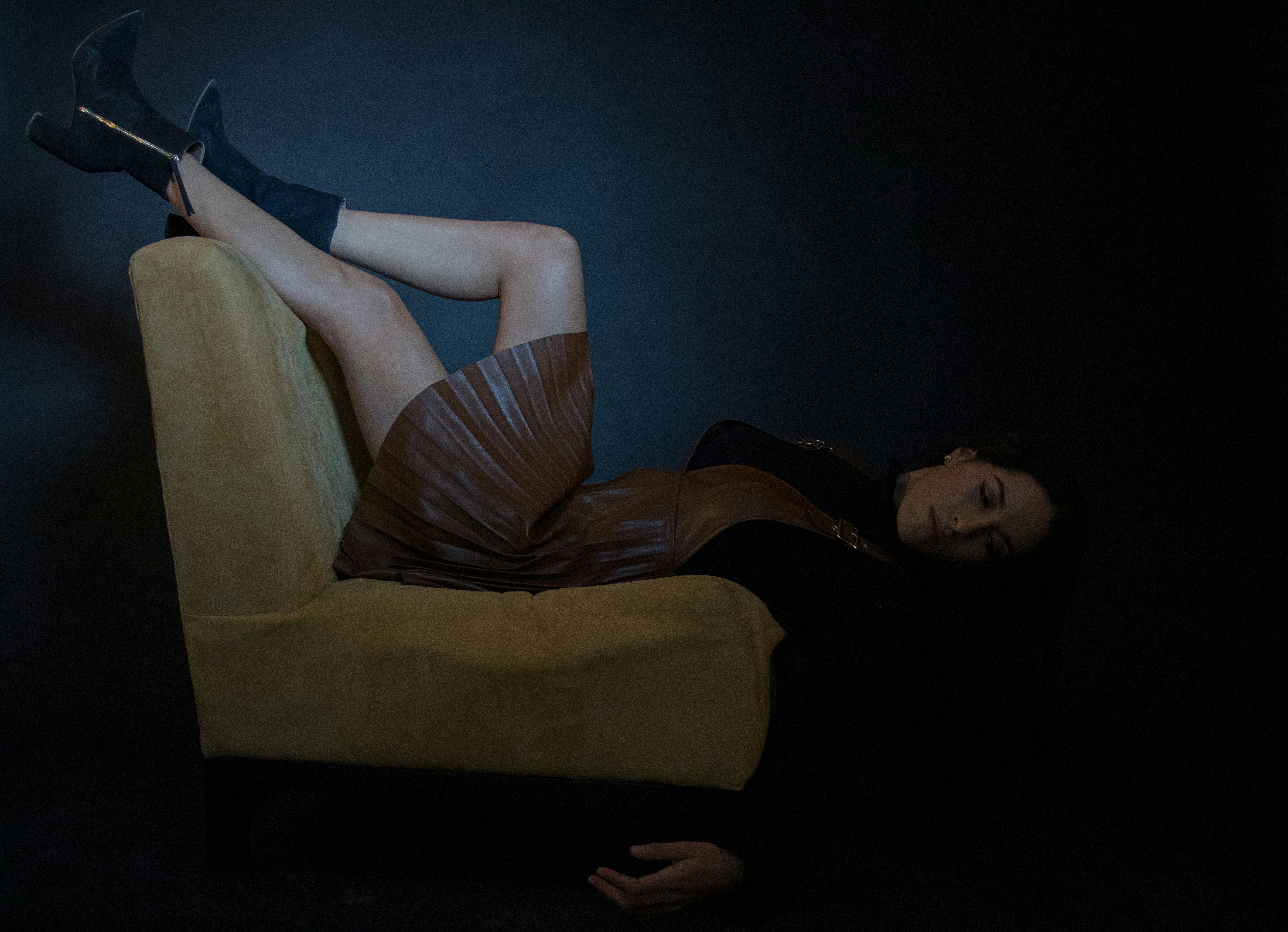 woman in gray shirt lying on yellow sofa