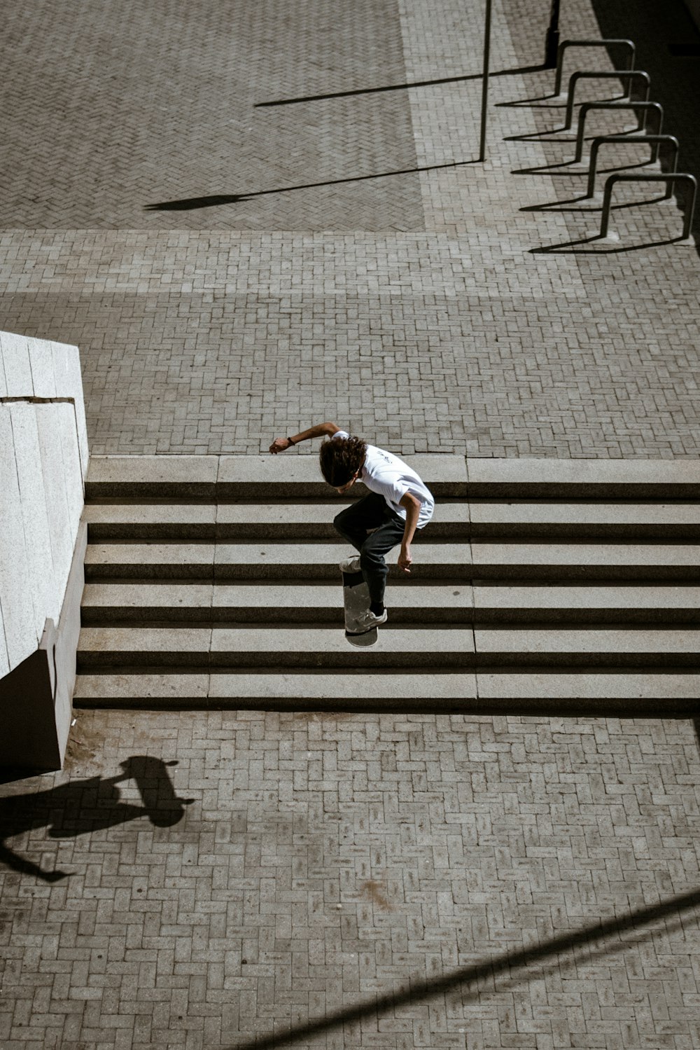 man in white shirt and pants jumping on pedestrian line during daytime