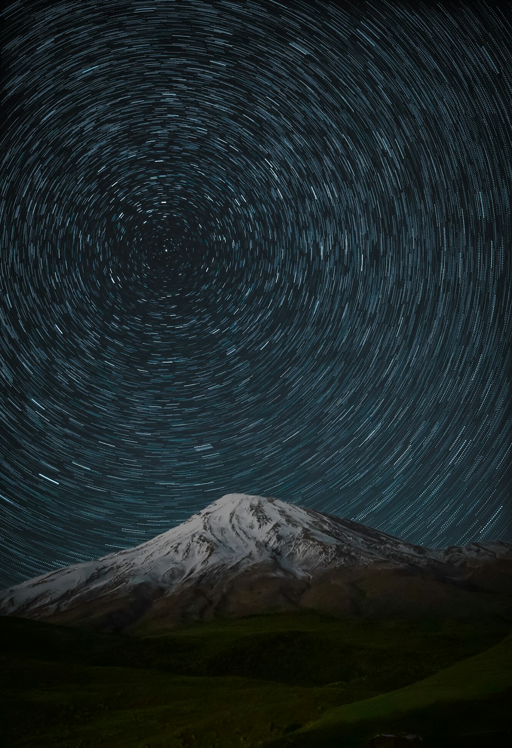 time lapse photography of stars above mountain