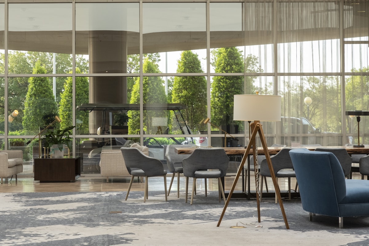 Modern hotel lobby with chairs and glass windows at dusk