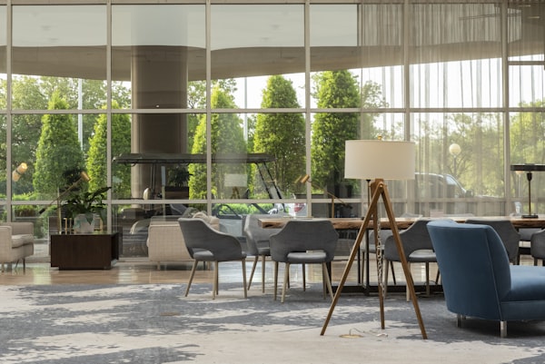Modern hotel lobby with chairs and glass windows at dusk