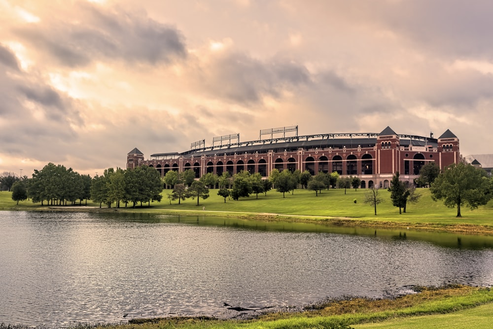 brown concrete building near river under cloudy sky during daytime