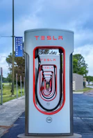 a tesla charging station on the side of the road