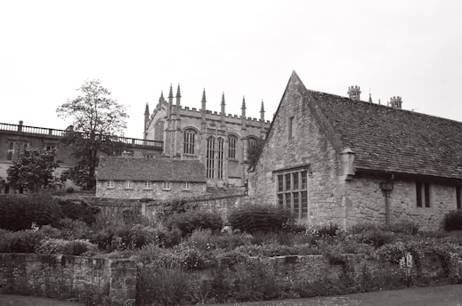 A stunning view of a historic Scottish school building surrounded by lush greenery.