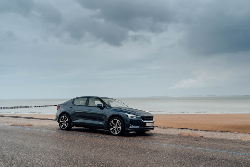 black bmw x 6 on beach shore during daytime