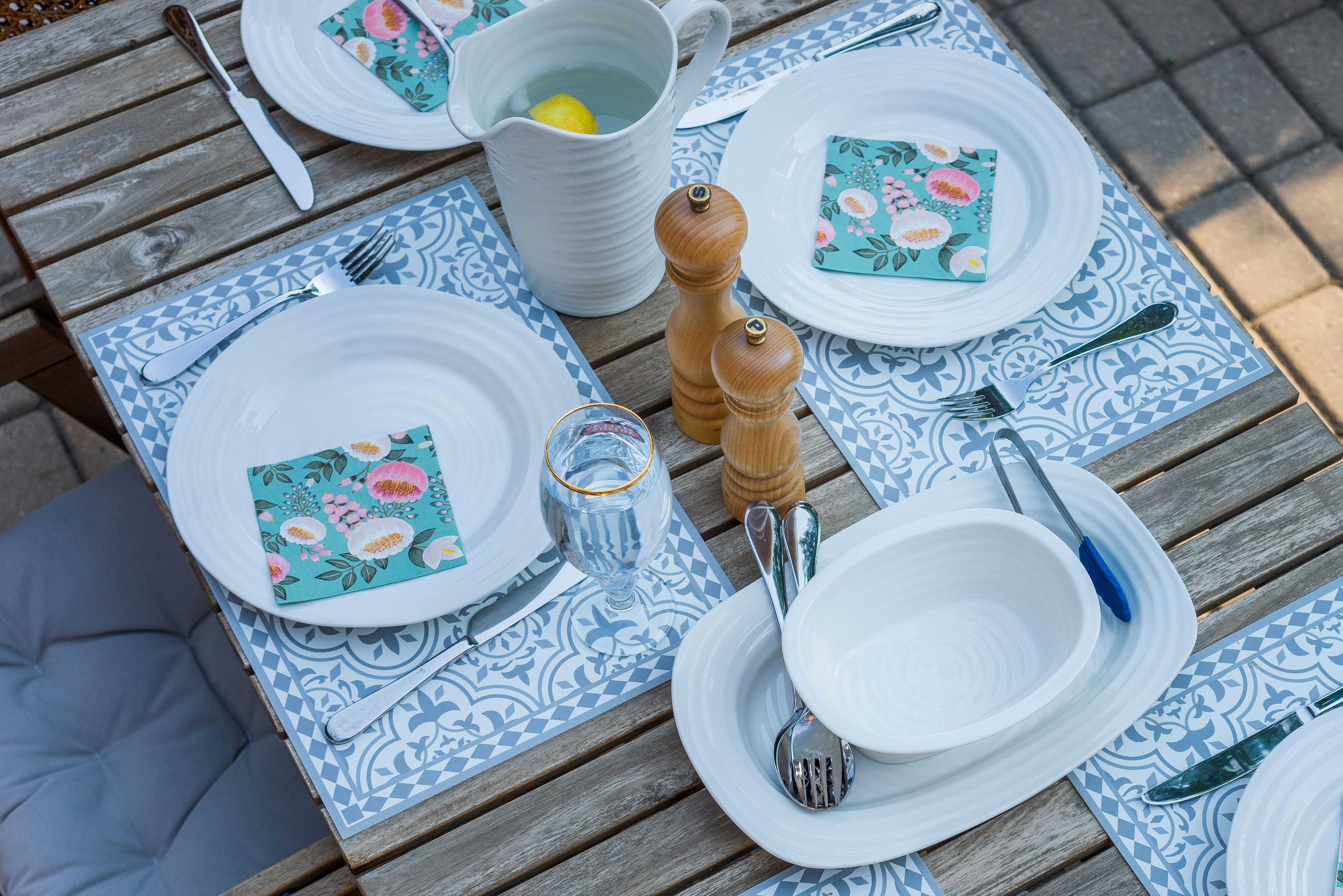 white ceramic plate beside clear drinking glass on table