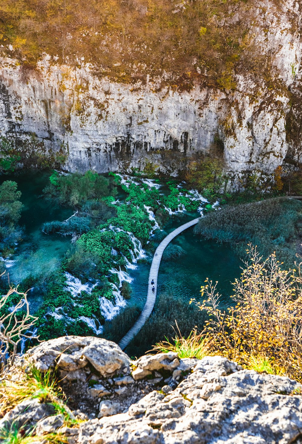 a river flowing through a canyon next to a cliff