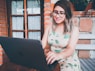 woman in green and white floral tank top wearing black framed eyeglasses