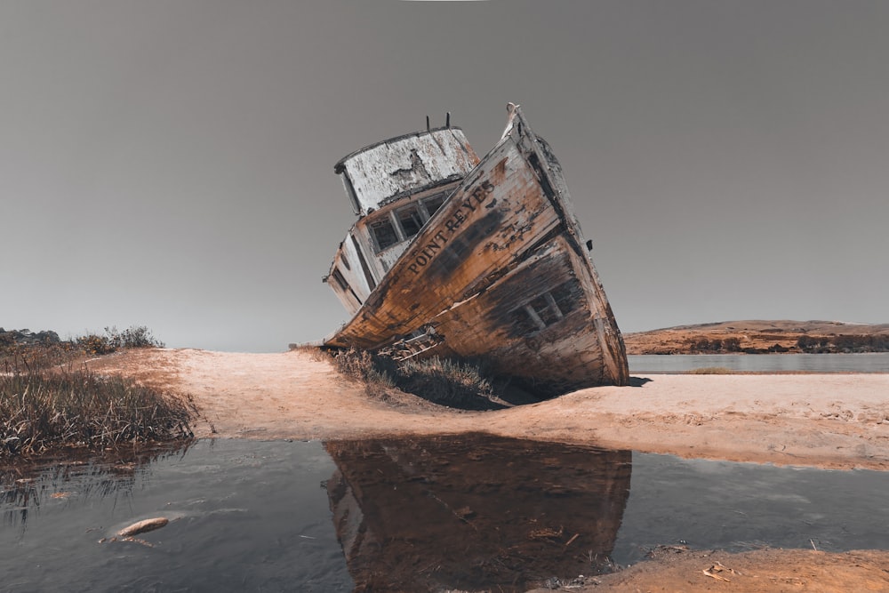brown and white ship on shore during daytime
