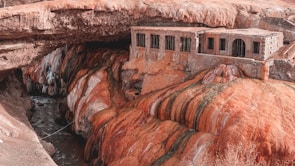 brown rock formation near body of water during daytime