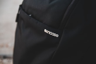 Close-up of capsule logo printed on a stylish backpack.