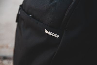 Close-up of capsule logo printed on a stylish backpack.