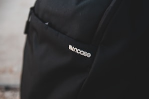 Close-up of a high-quality thermal delivery backpack with a custom logo stitched on the front pocket.