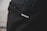 A close-up view of a black backpack with a subtle texture, featuring a small silver logo that reads 'incase'.