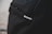 A close-up view of a black backpack with a subtle texture, featuring a small silver logo that reads 'incase'.