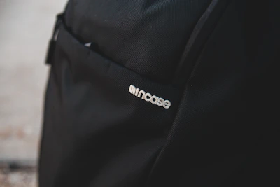Close-up of a backpack with a sleek, custom iron-on label showing a child's name in elegant typography.