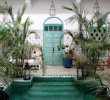 Inviting courtyard with lush greenery and traditional Moroccan lanterns.