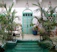 A serene courtyard terrace bathed in warm Moroccan sunlight with lush greenery.