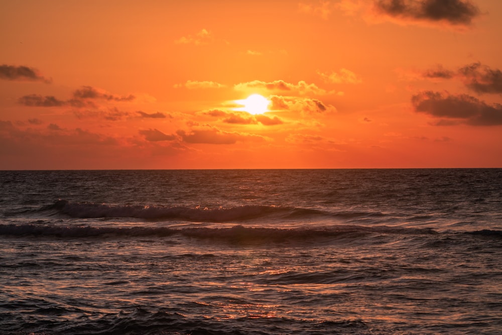 body of water during sunset