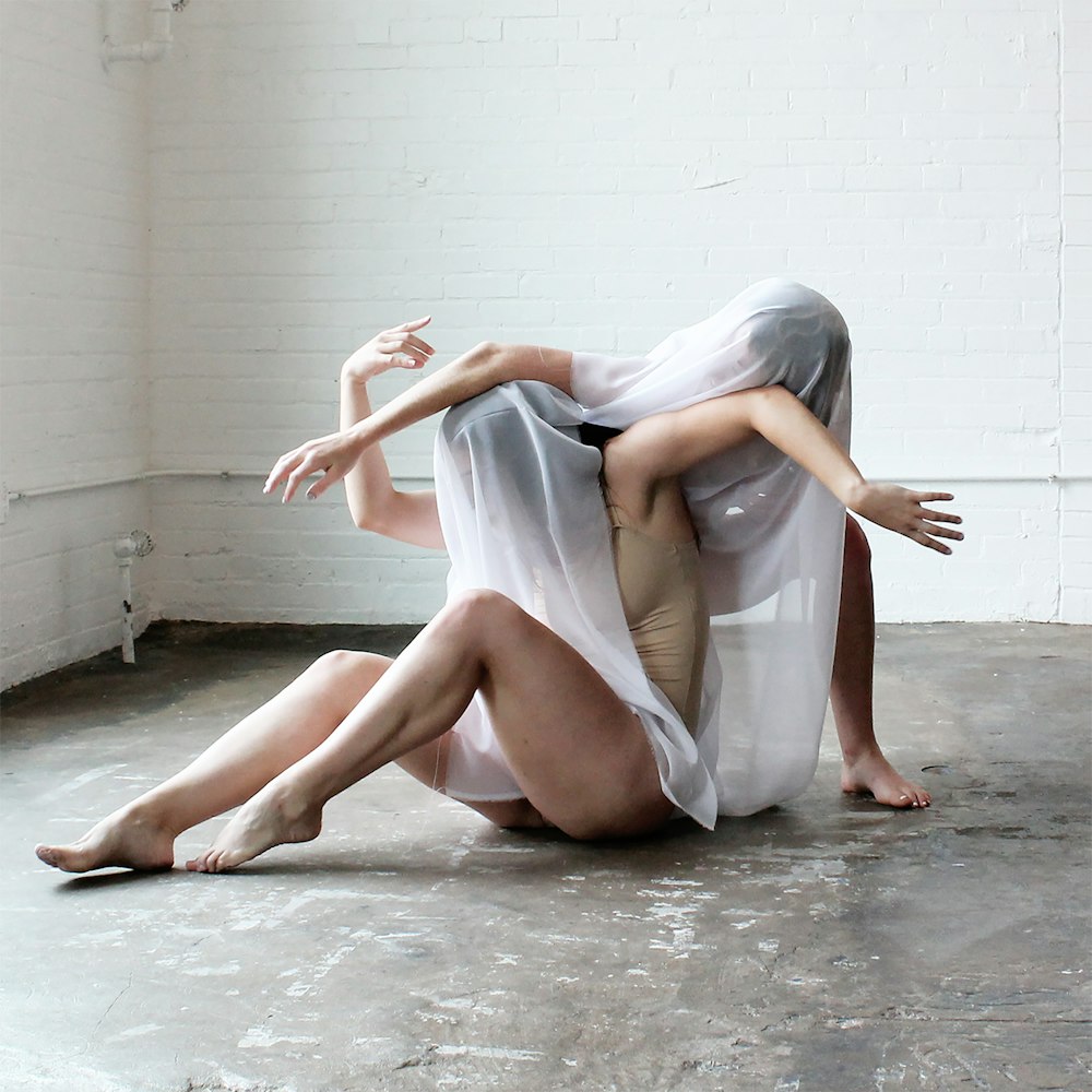 woman in white dress sitting on floor