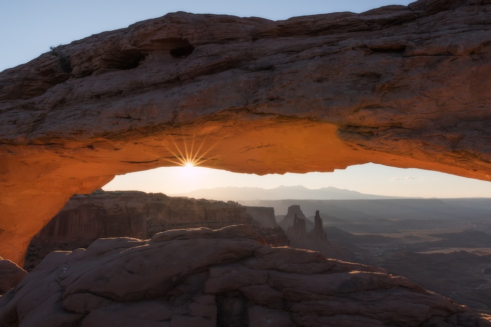 person standing on rock formation during daytime