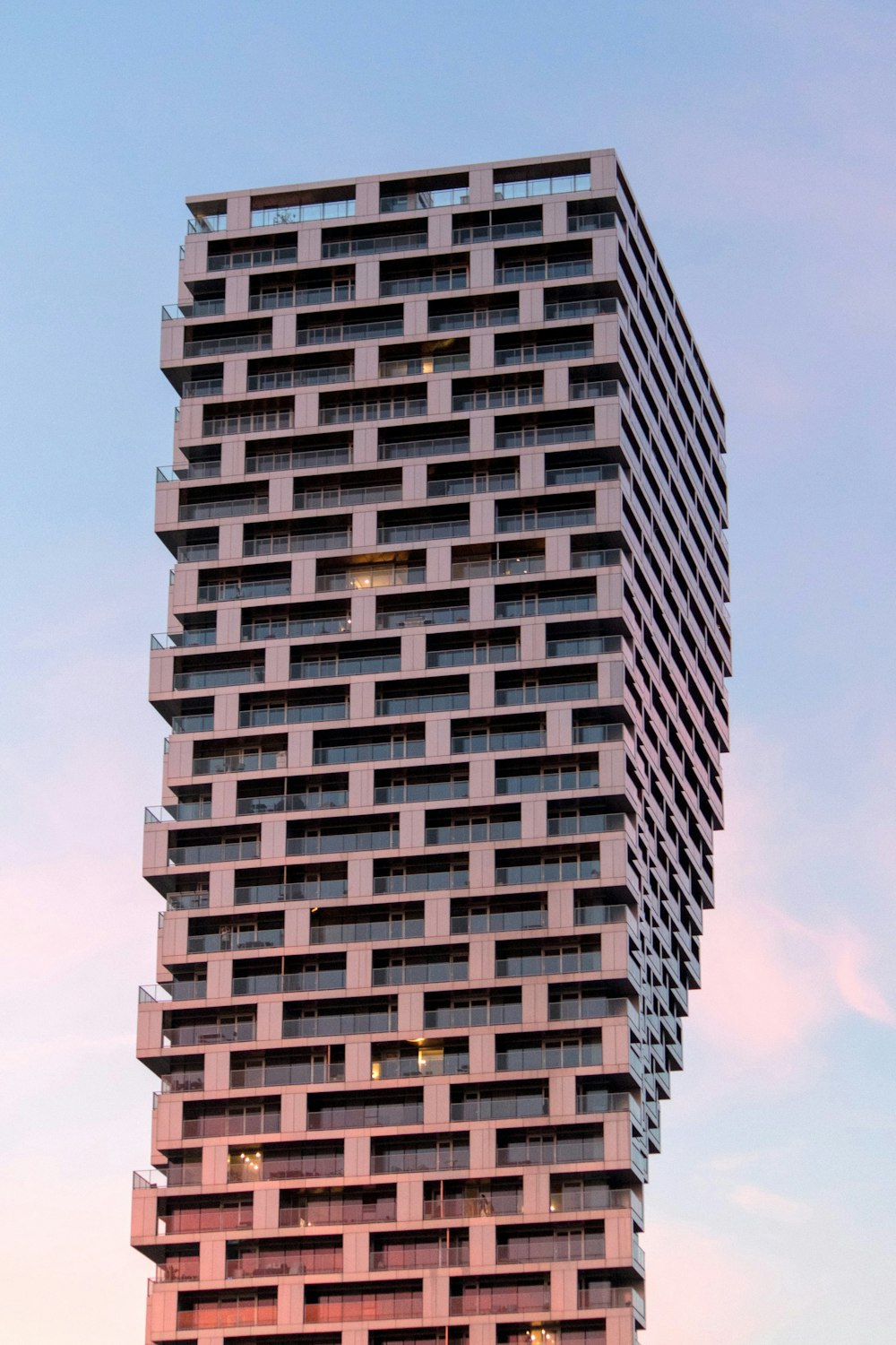 brown and black concrete building under blue sky during daytime