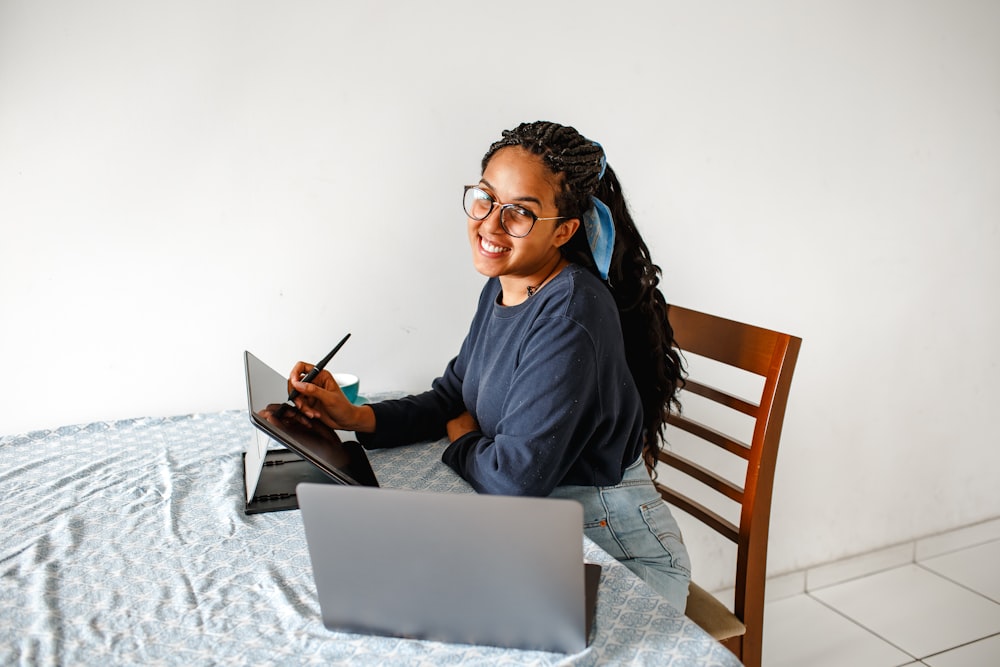 woman in blue long sleeve shirt using macbook