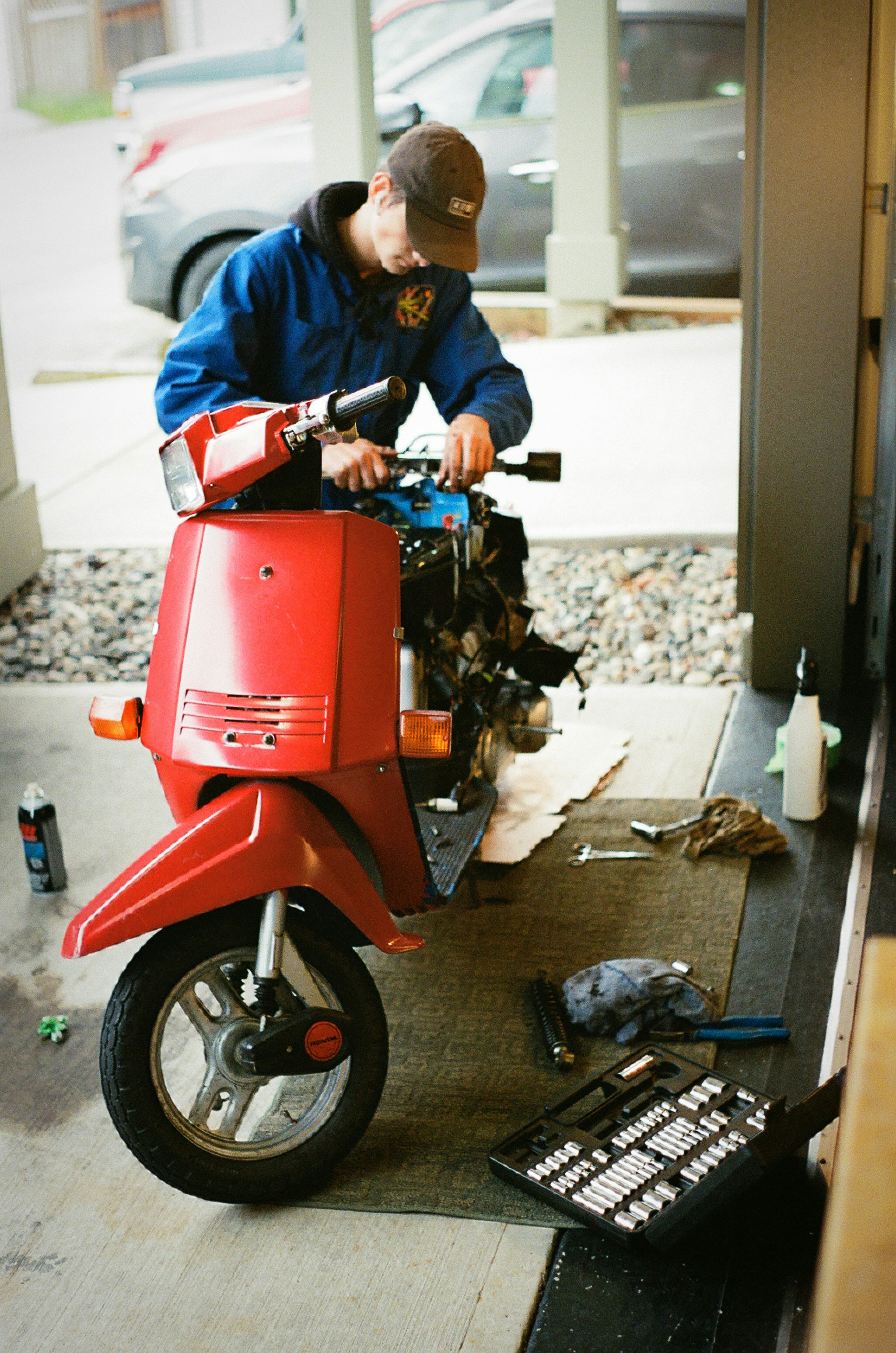 man in white jacket riding red motorcycle