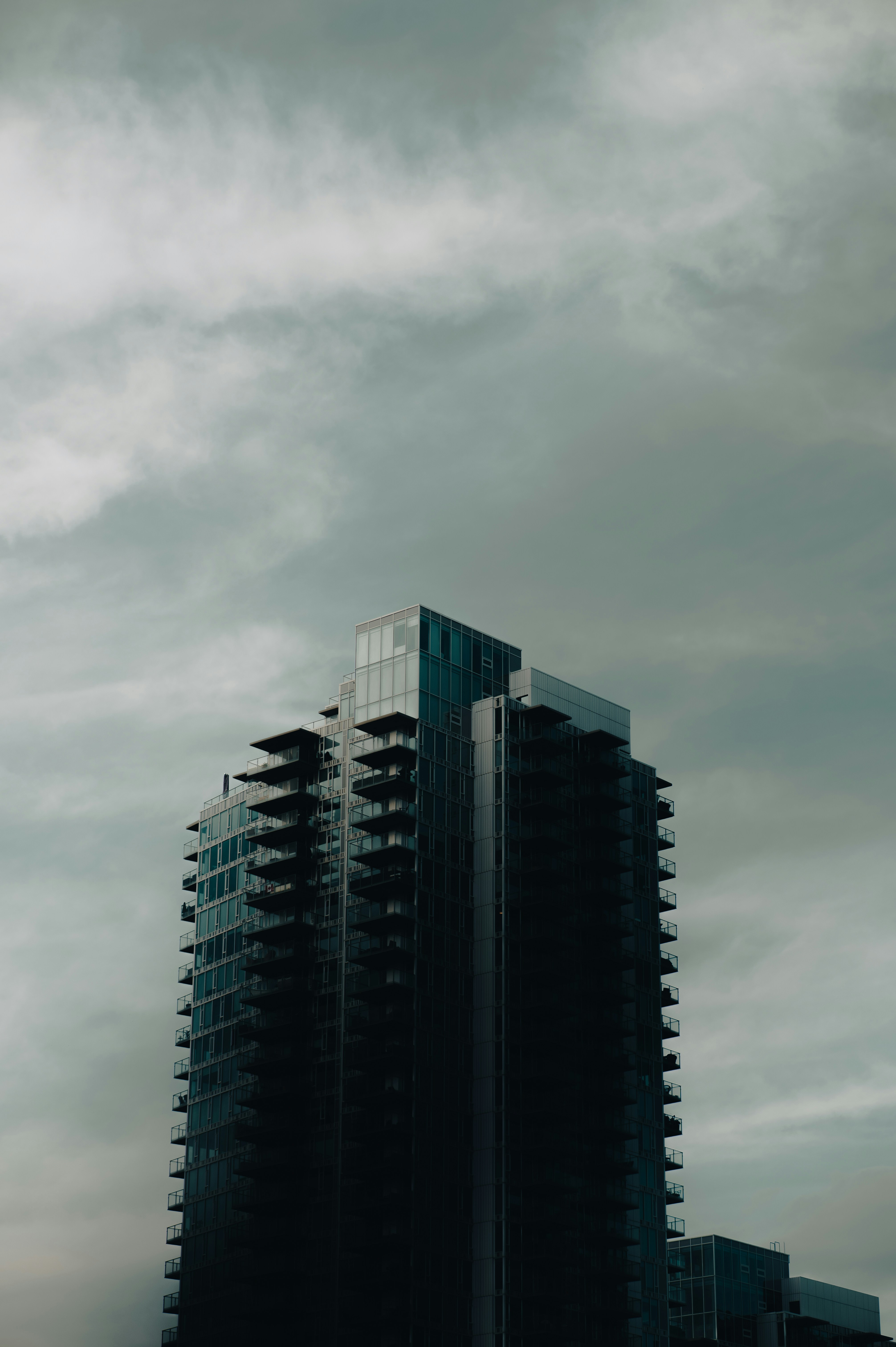 black and white concrete building under white clouds