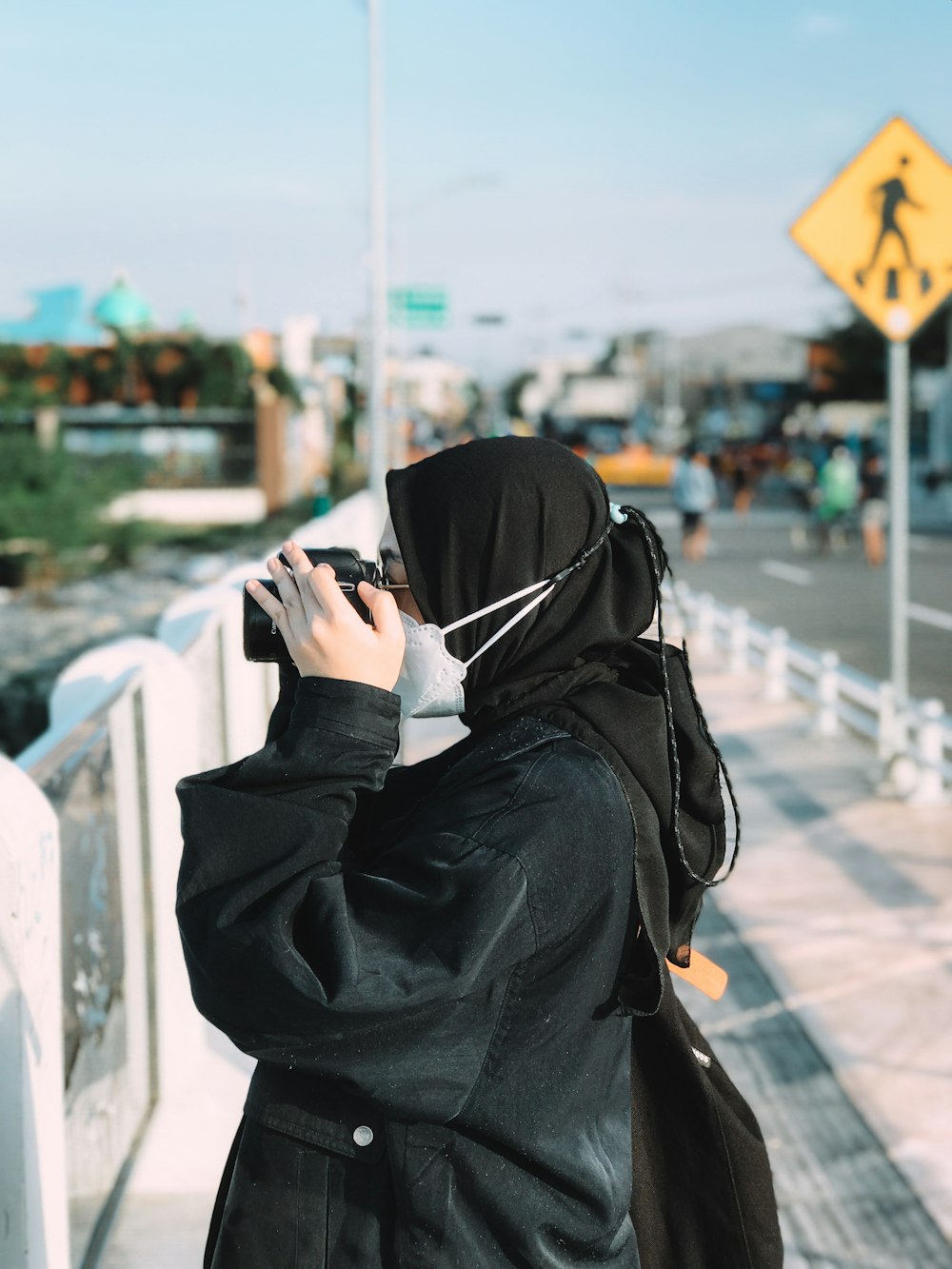 person in black hoodie using smartphone during daytime