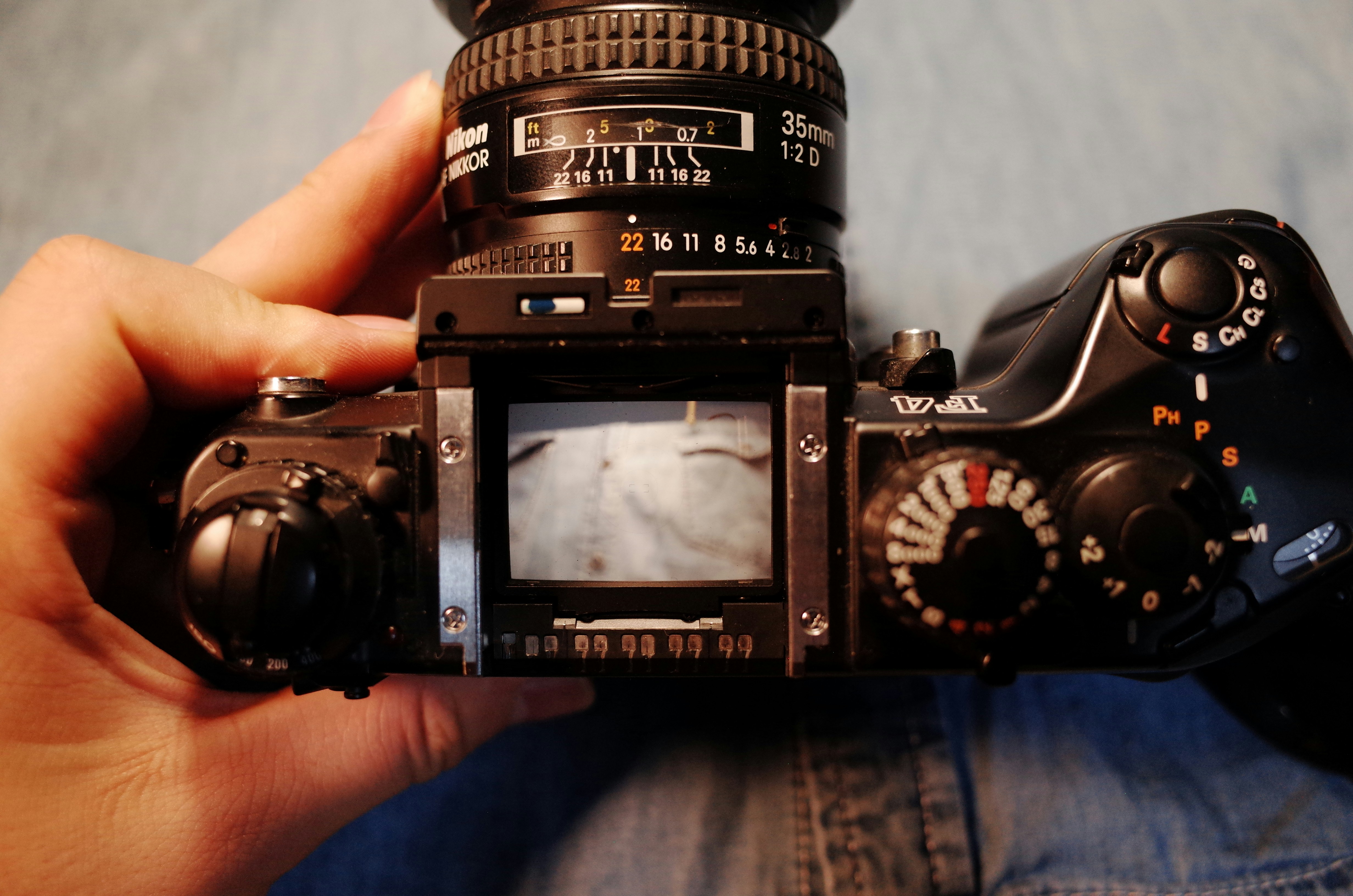 black nikon dslr camera on persons hand