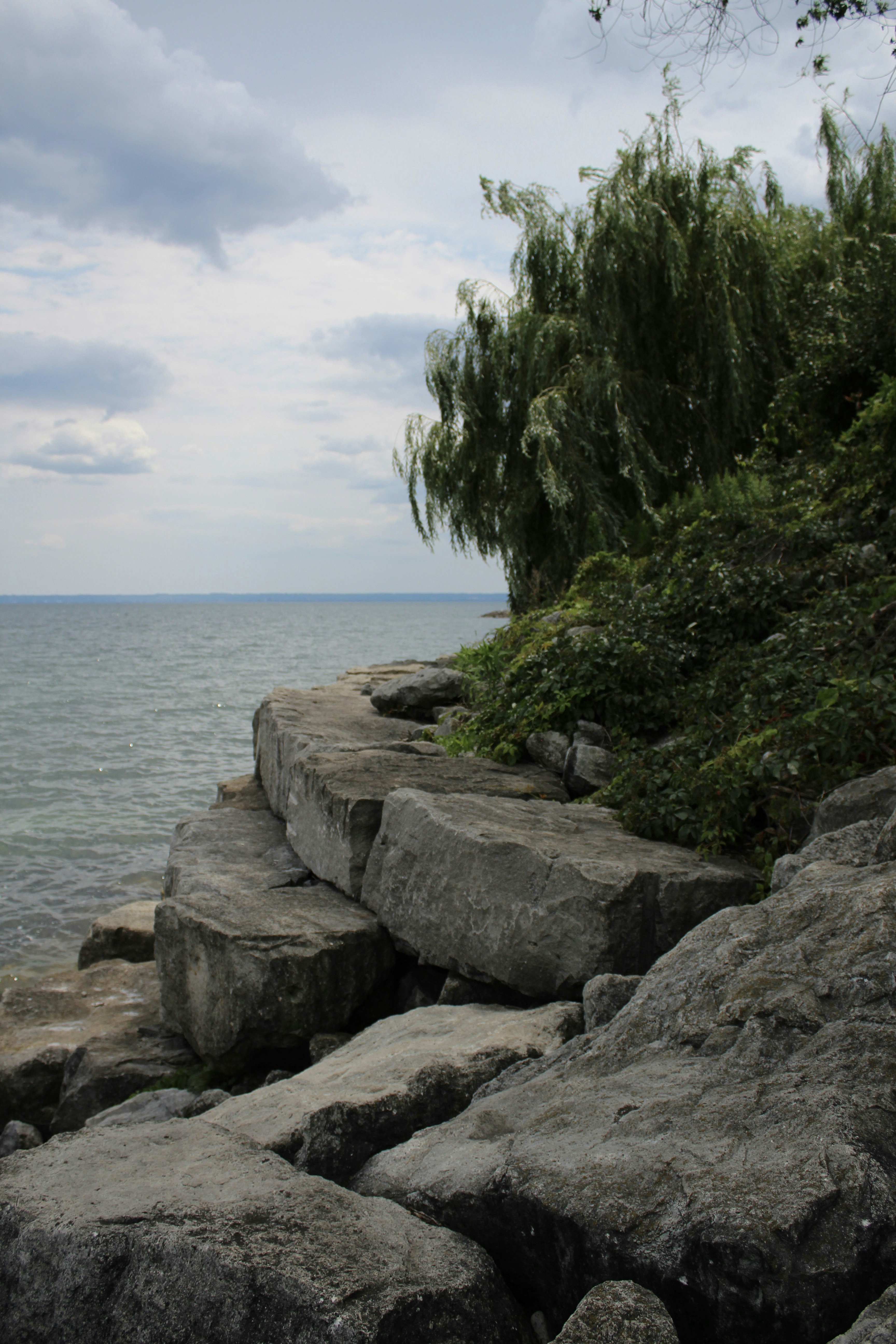 Gray rocks near body of water during daytime photo – Free Beach Image ...