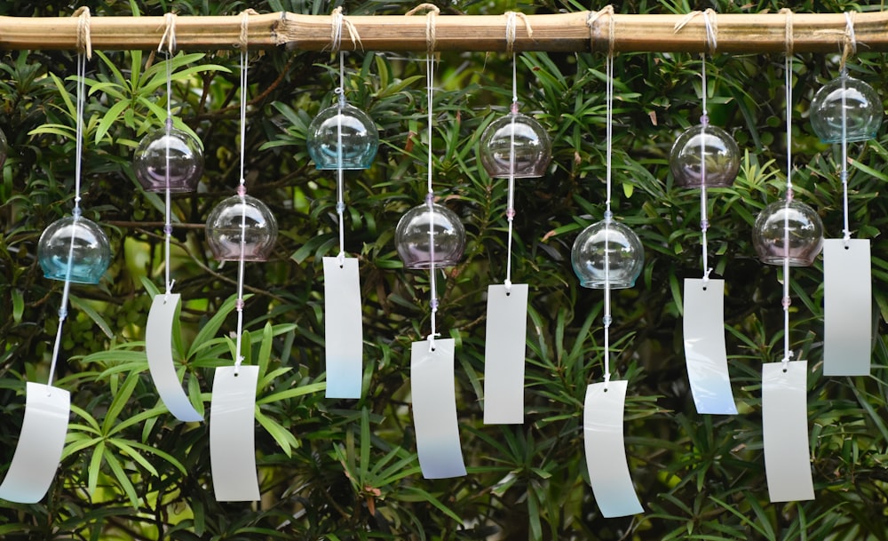 silver round hanging decors on brown wooden fence