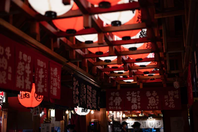 Elegant Japanese-inspired interior with maroon and gold soft lighting creating a calming atmosphere