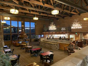 A warm, inviting resort lobby with rustic wooden decor and soft lighting.
