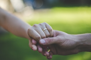A beautifully lit engagement couple holding hands in a serene outdoor setting