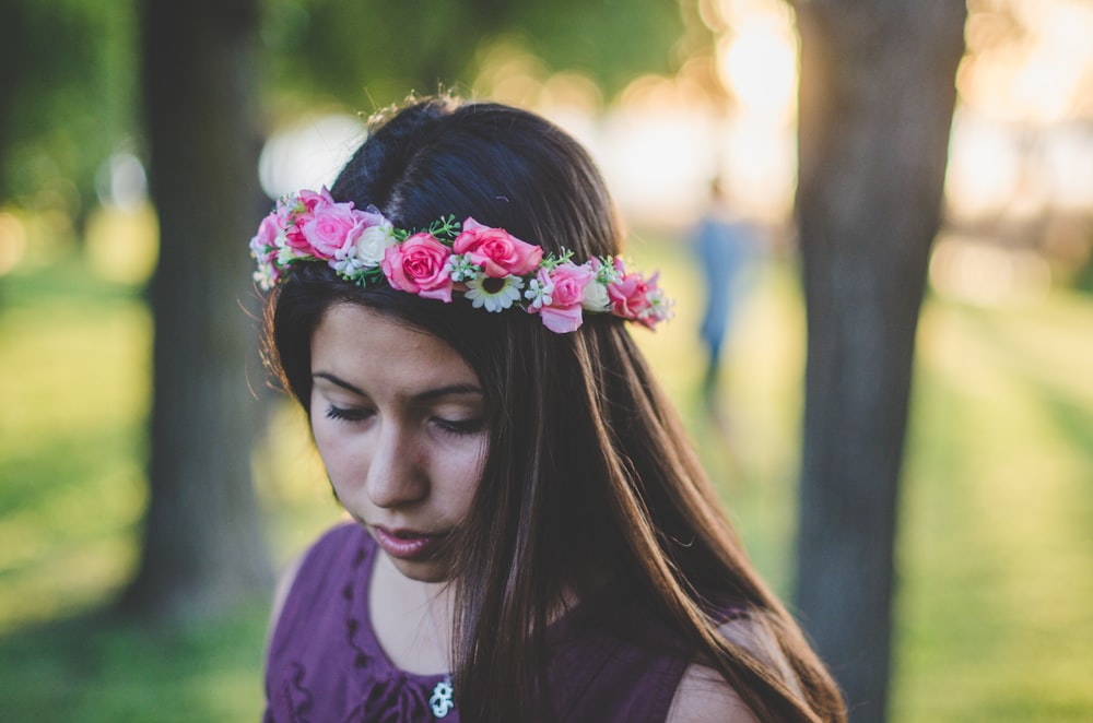 girl in purple and pink floral shirt with pink flower headband