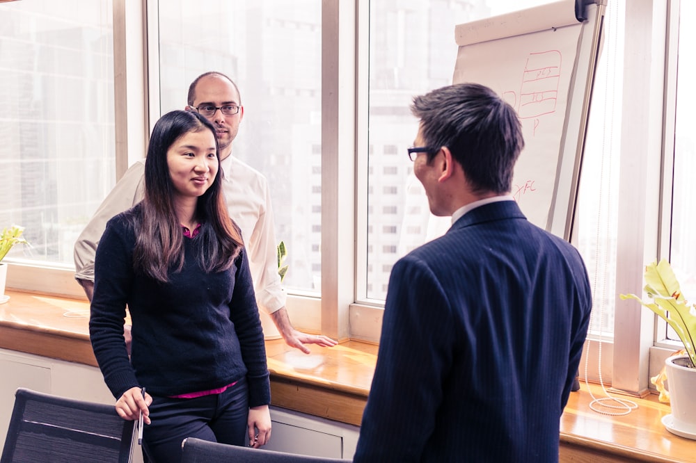 man in black sweater standing beside woman in black long sleeve shirt