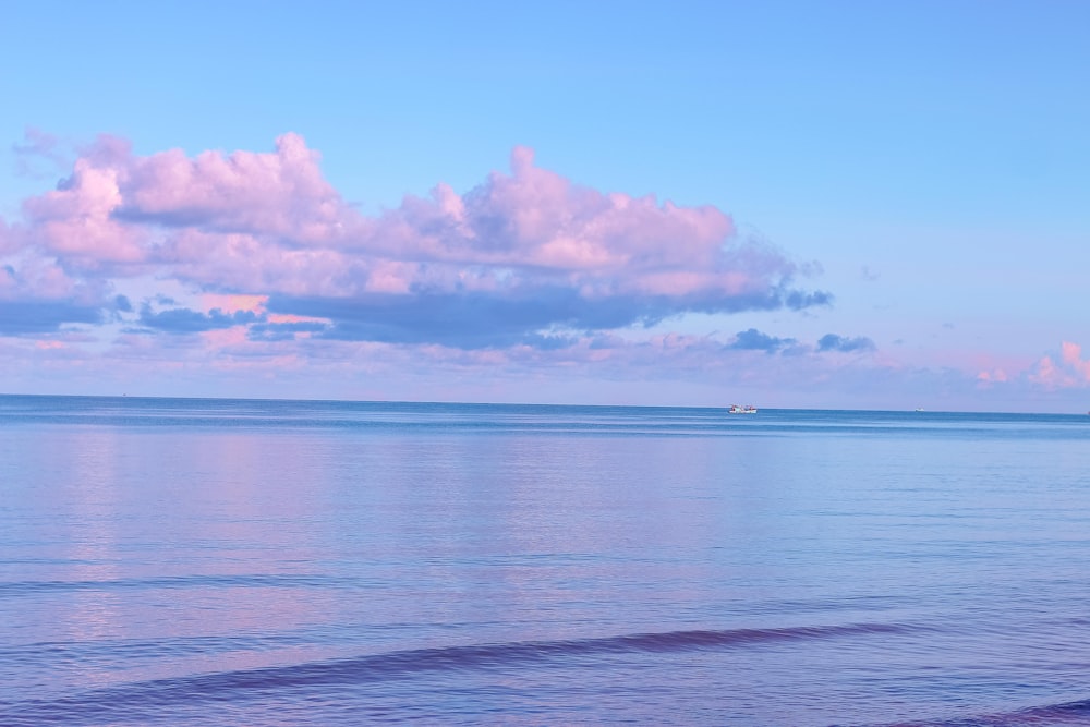 blue sea under blue sky and white clouds during daytime