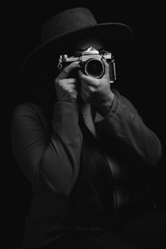 woman holding black and silver camera