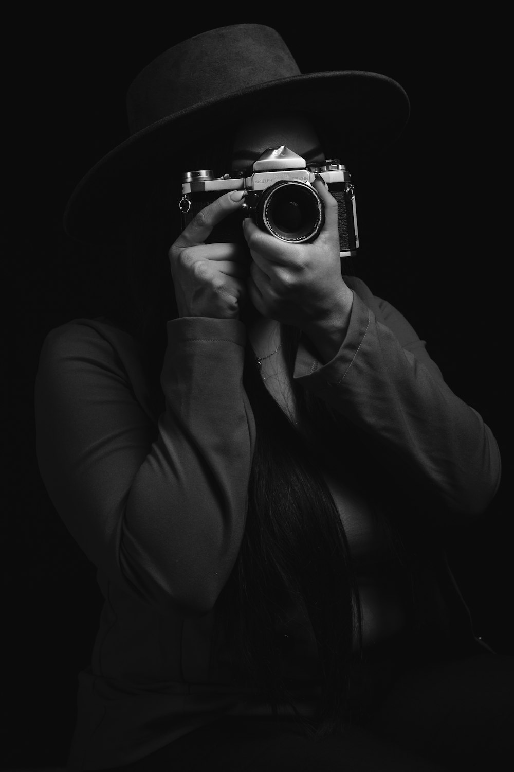 woman holding black and silver camera