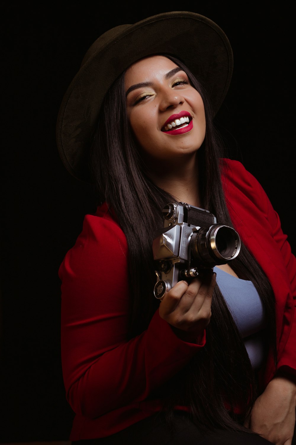 woman in red long sleeve shirt holding black and silver dslr camera