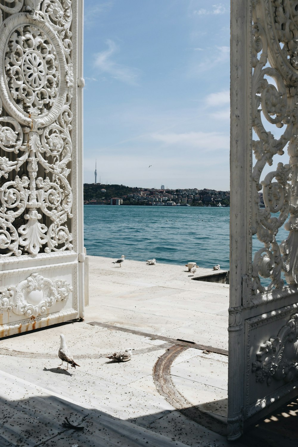 white concrete statue near body of water during daytime