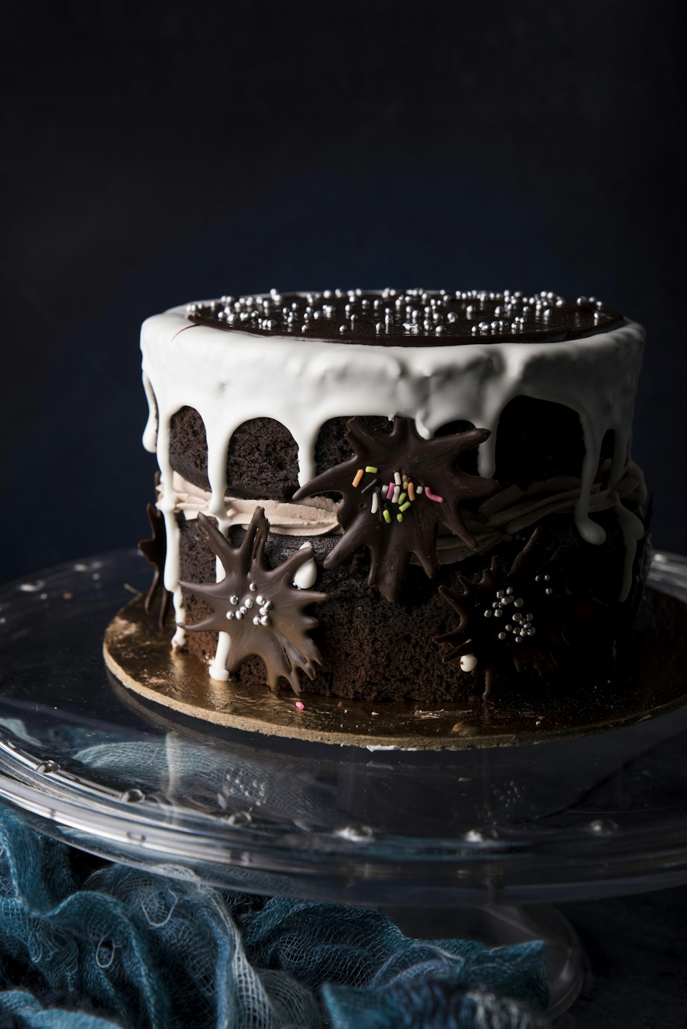 white and black cake on blue glass plate